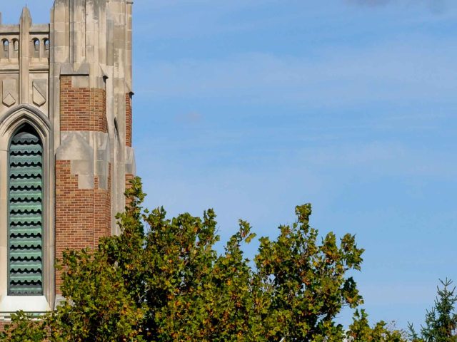 Image of the top of Beaumont Tower set against a blue sky.
